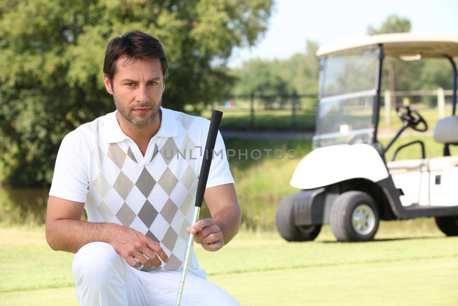Golfer looking at the lie of his ball by phovoir