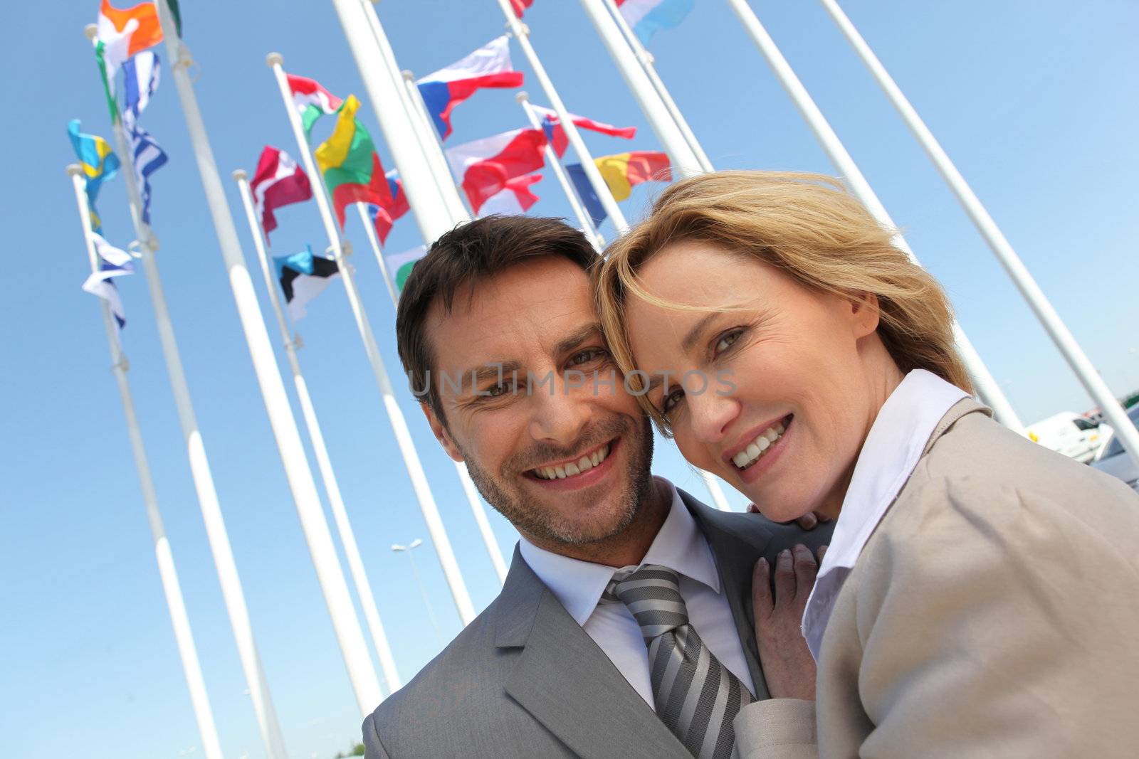 Businessman and woman with flags. by phovoir