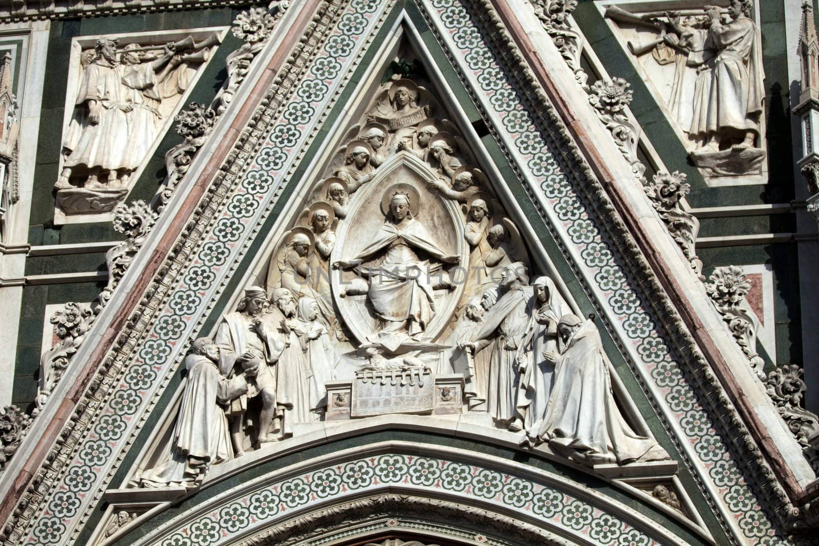 Florence - beautiful composition with  Virgin Mary above the portal on the facade of the Santa Maria del Fiore cathedral