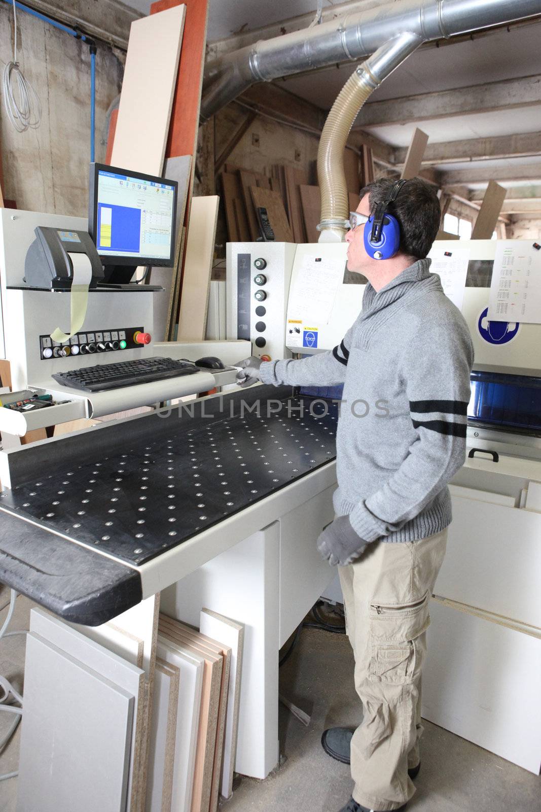 Man working in a factory by phovoir