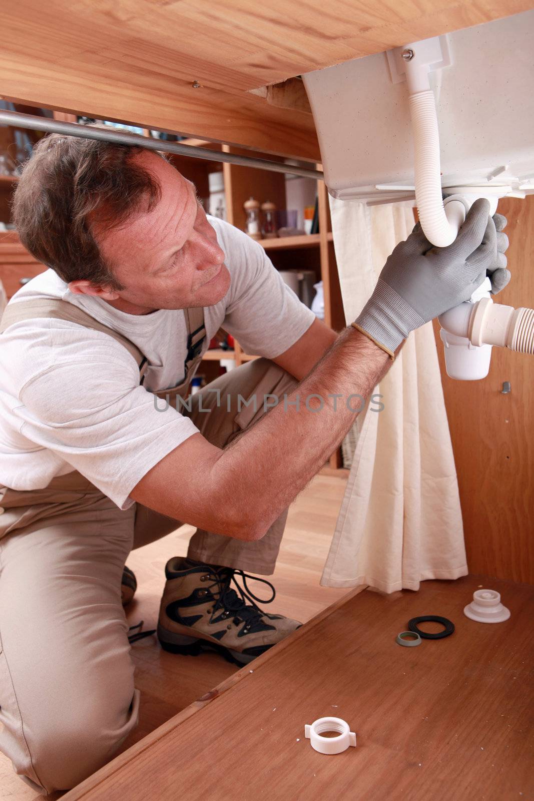 Labourer fixing sink by phovoir