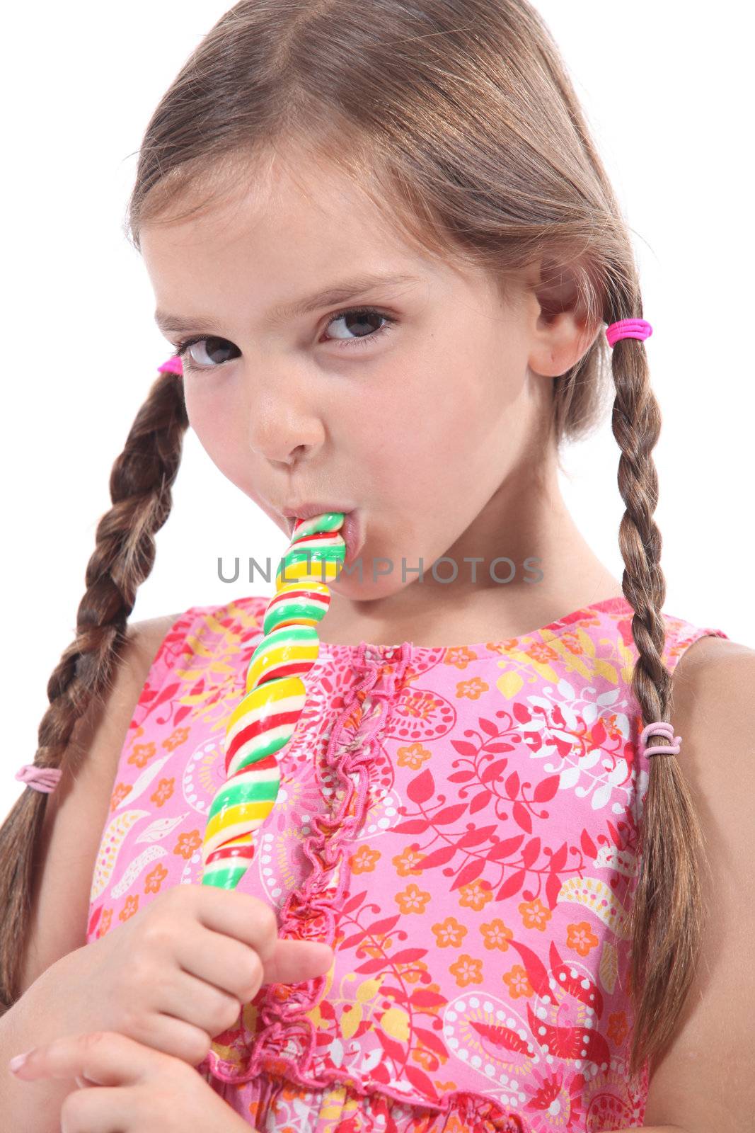 Girl sucking on a candy stick