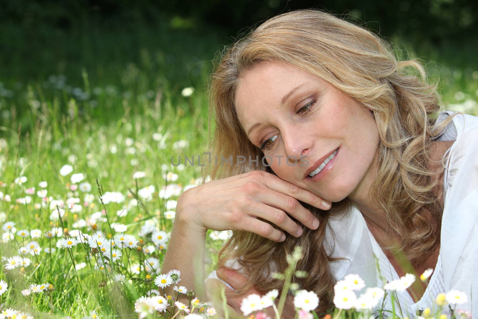 Woman lying in daisies