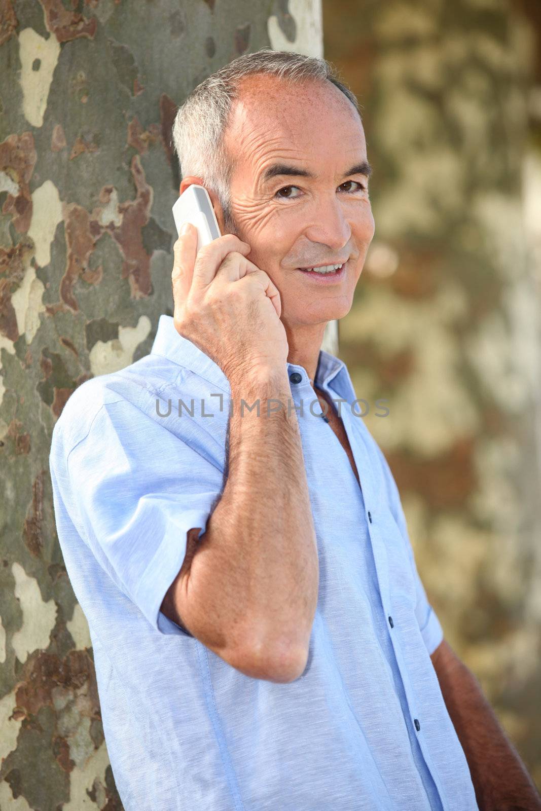 senior man at phone by phovoir