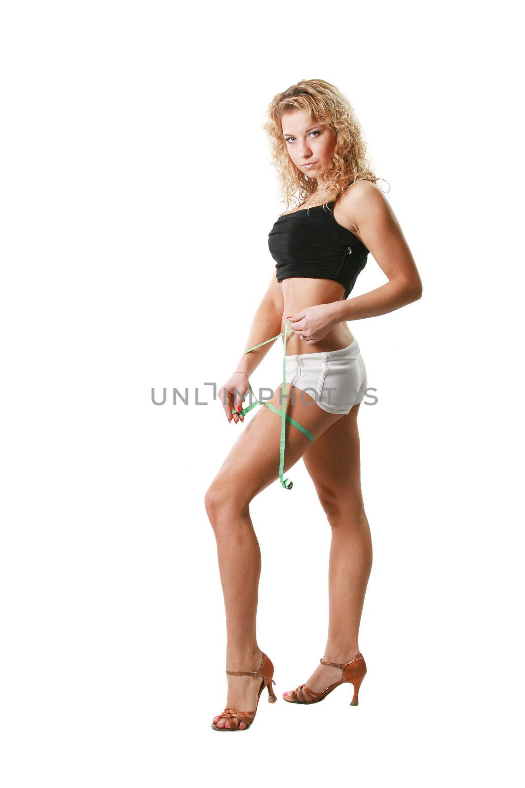 The sports attractive woman measures a hip