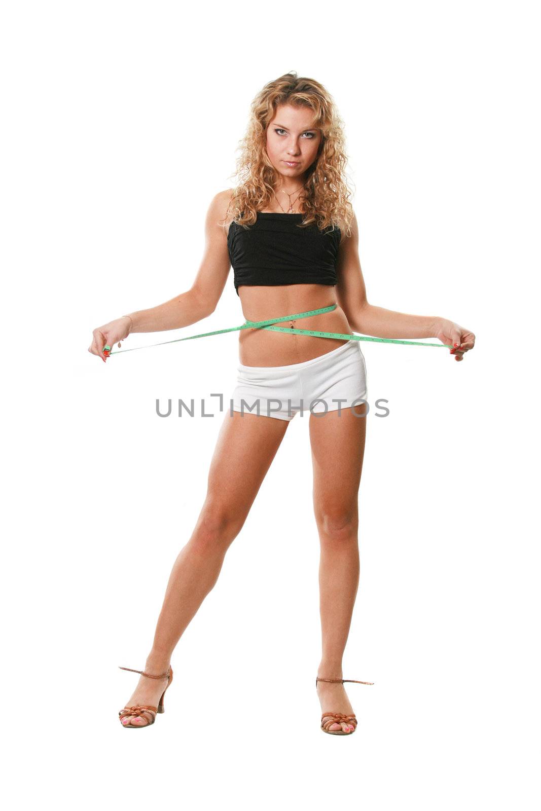 The sports attractive woman measures a waist