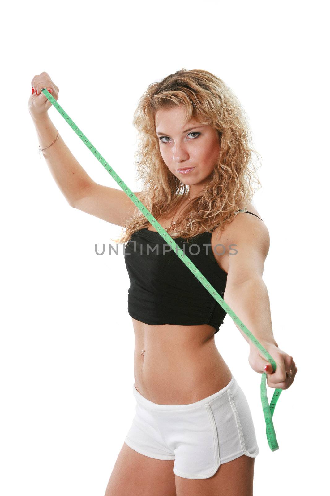 The sports attractive woman holds centimeter in hands