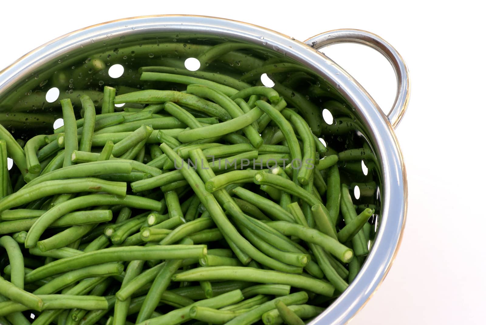 Bunch of french beans in a strainer.