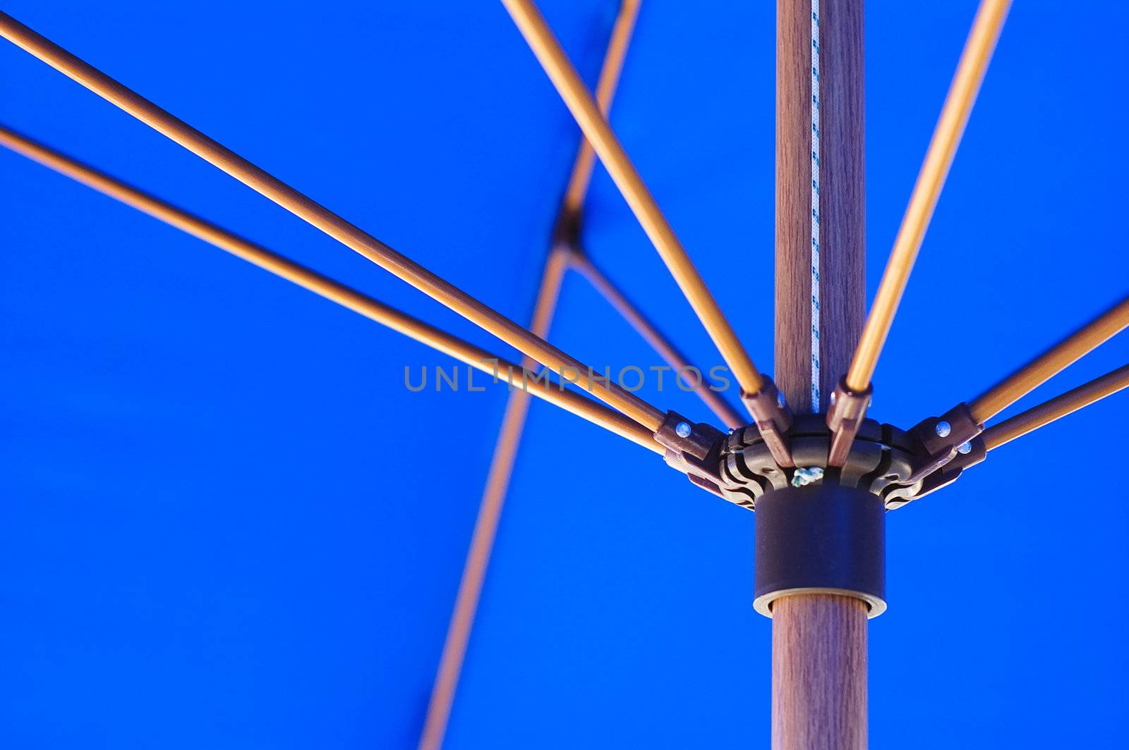 Close-up of inside of blue parasol and wood frame