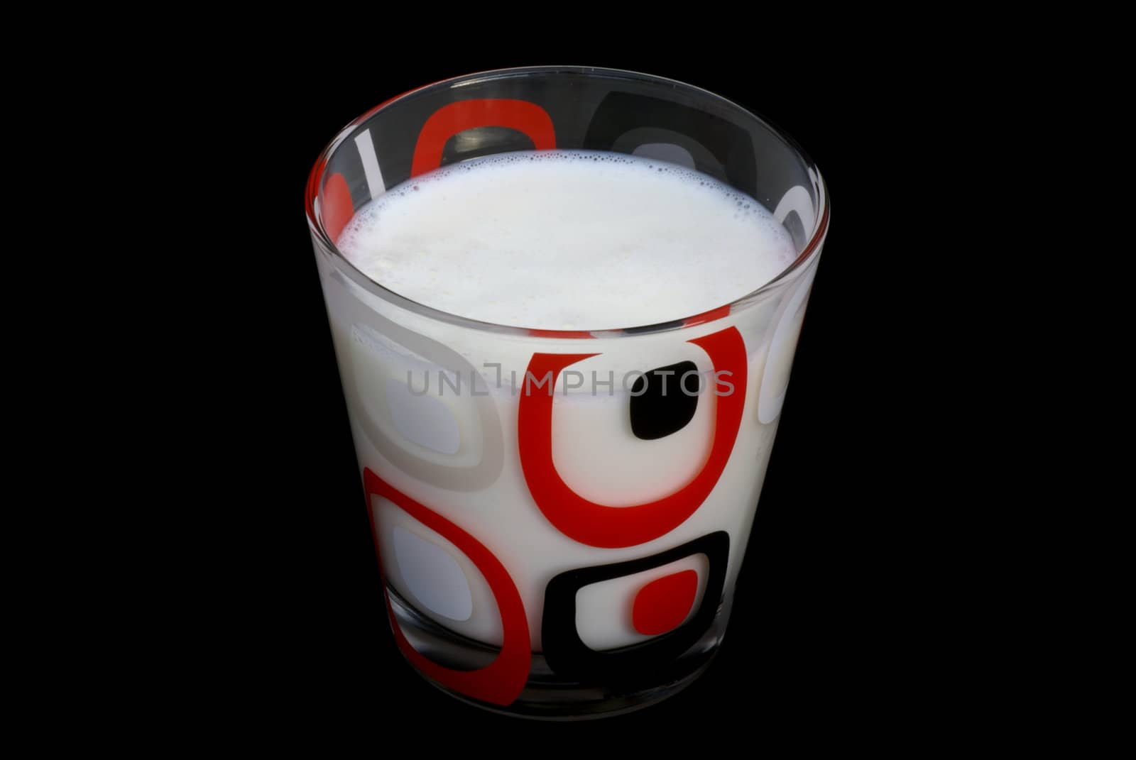 Glass of milk isolated on a black background.