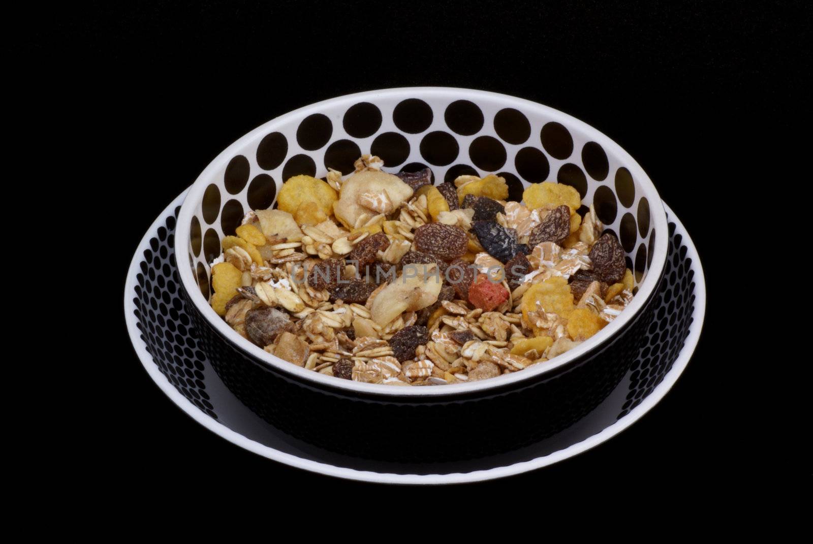 Bowls with muesli on a black background.