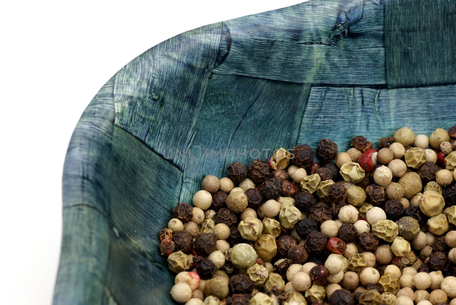 An isolated bowl of peppercorns.