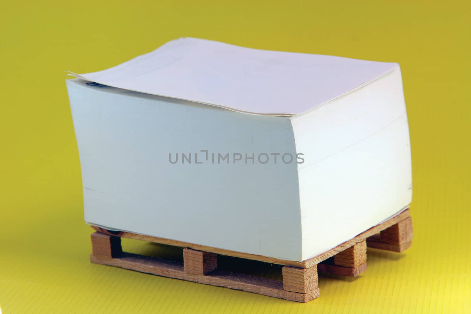 wooden paper palete miniature in yellow background