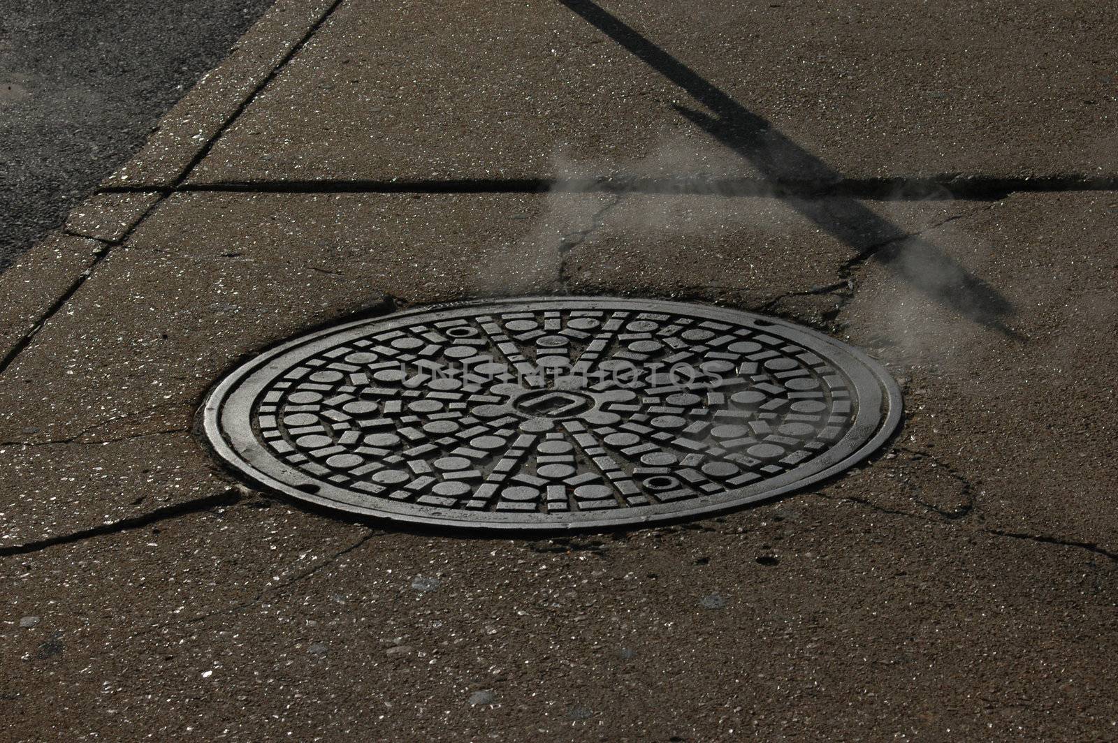                                 Closeup of a manhole in an urban city