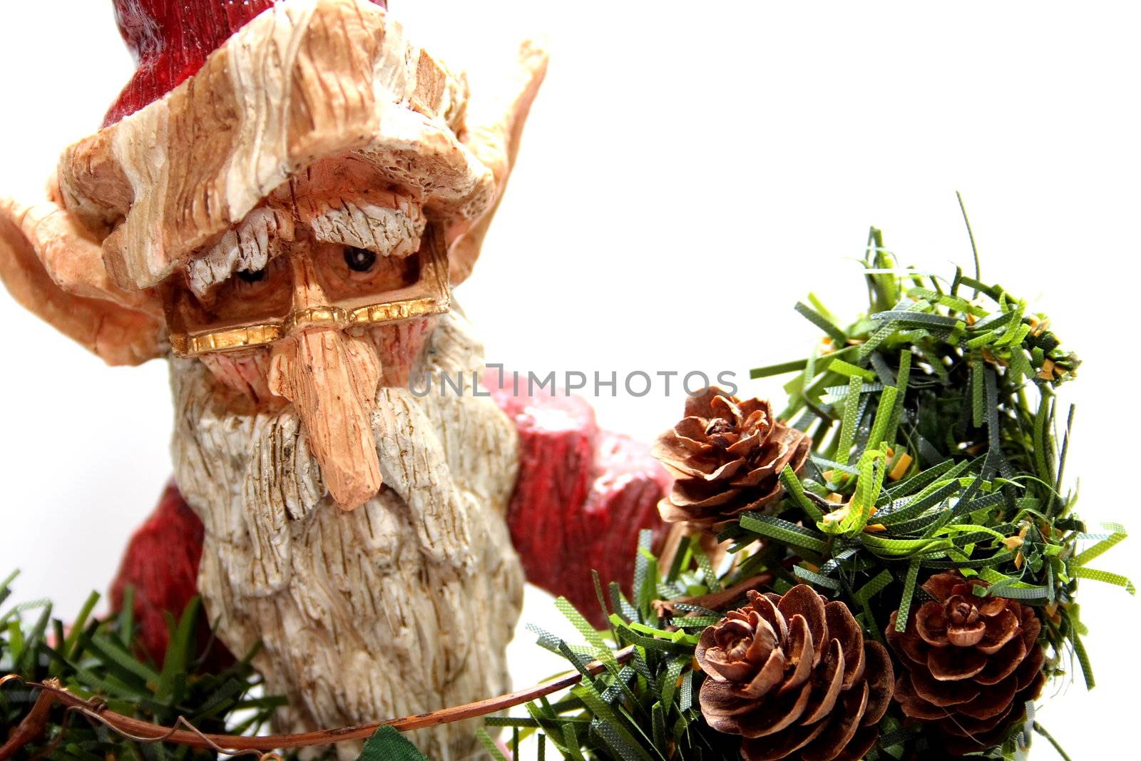 A wooden carving of Santa Claus elf on white background.