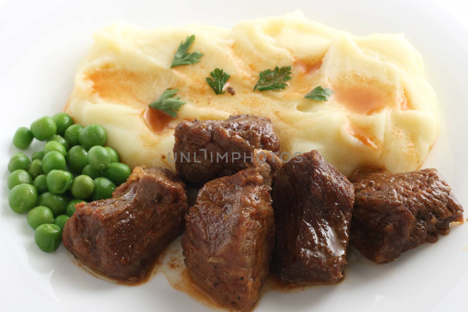 fried beef with mashed potato and peas