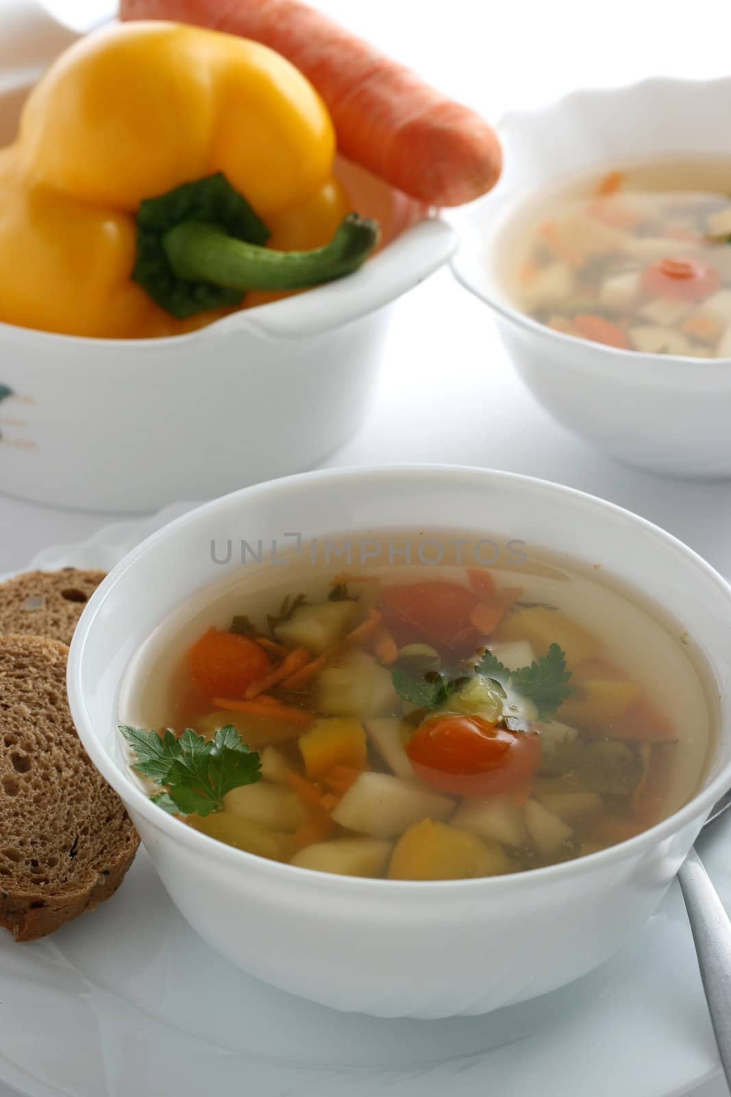 vegetable soup in white bowl by nataliamylova