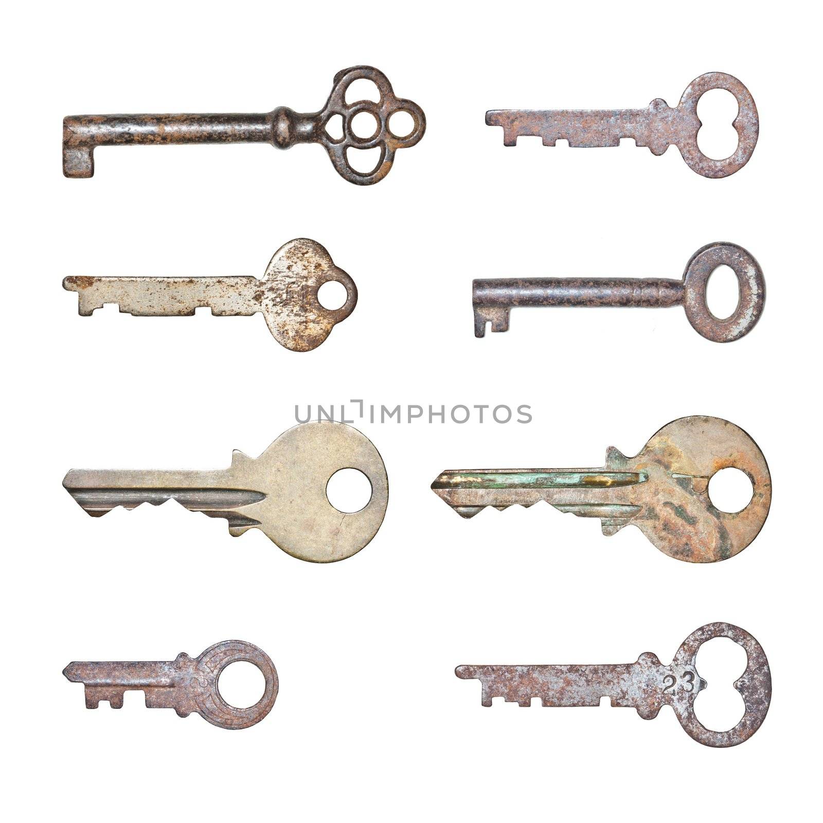 A collection of rusty old keys in isolated white background
