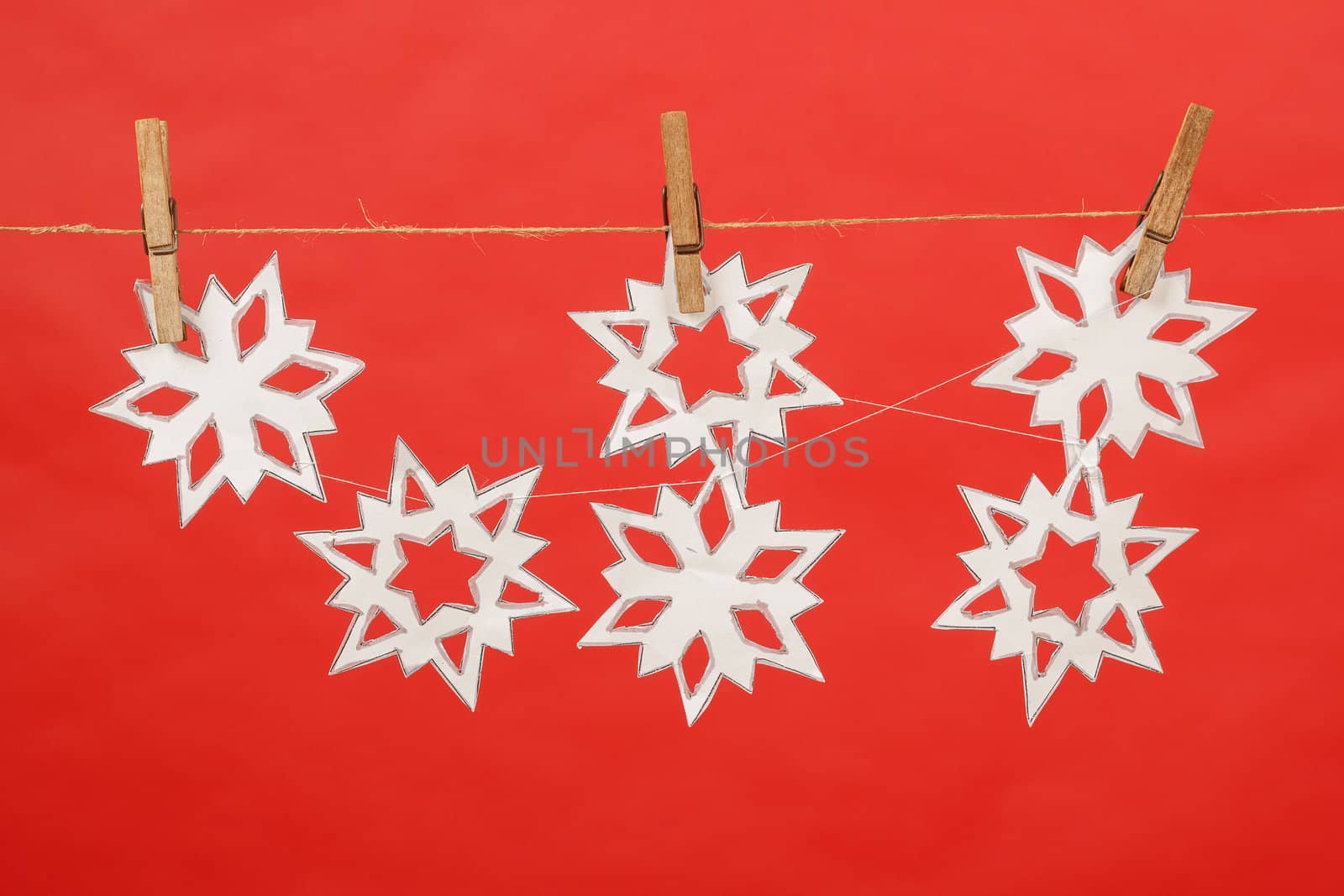 decoration produced by child hanging on red background