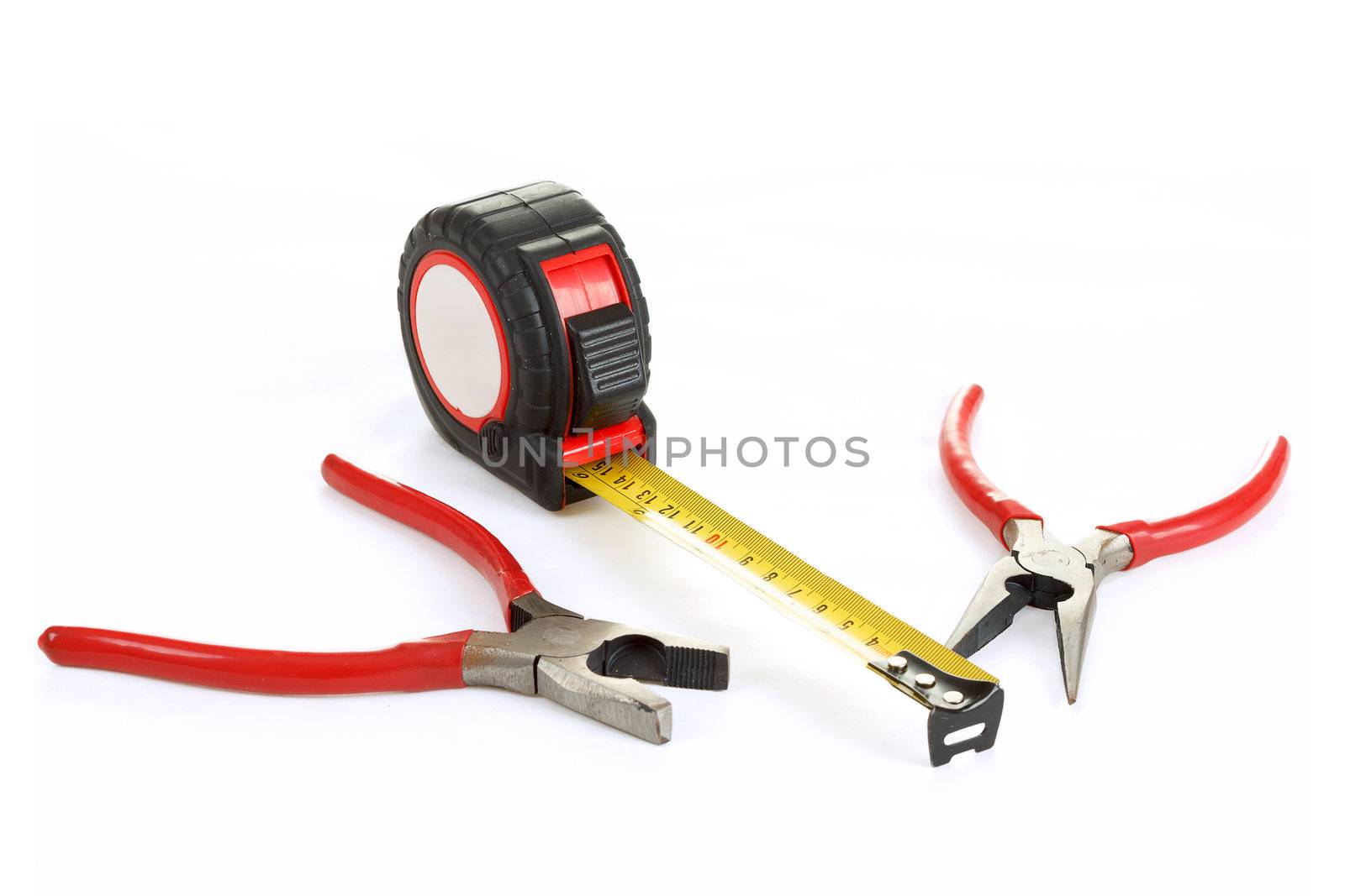 two different red pliers and measuring tape isolated on white