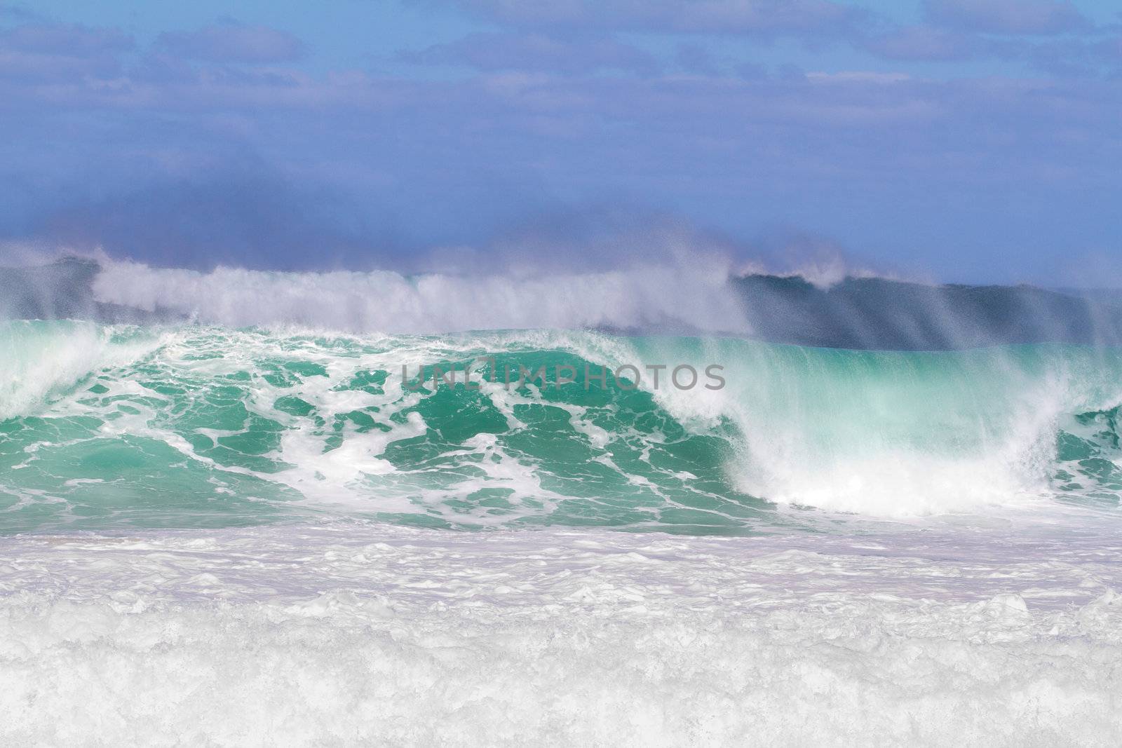 These monster waves are coming in by the set and standing over 20 feet tall. The surf is dangerous and the waves are very intimidating but there is a competition for surfers happening at the same time.