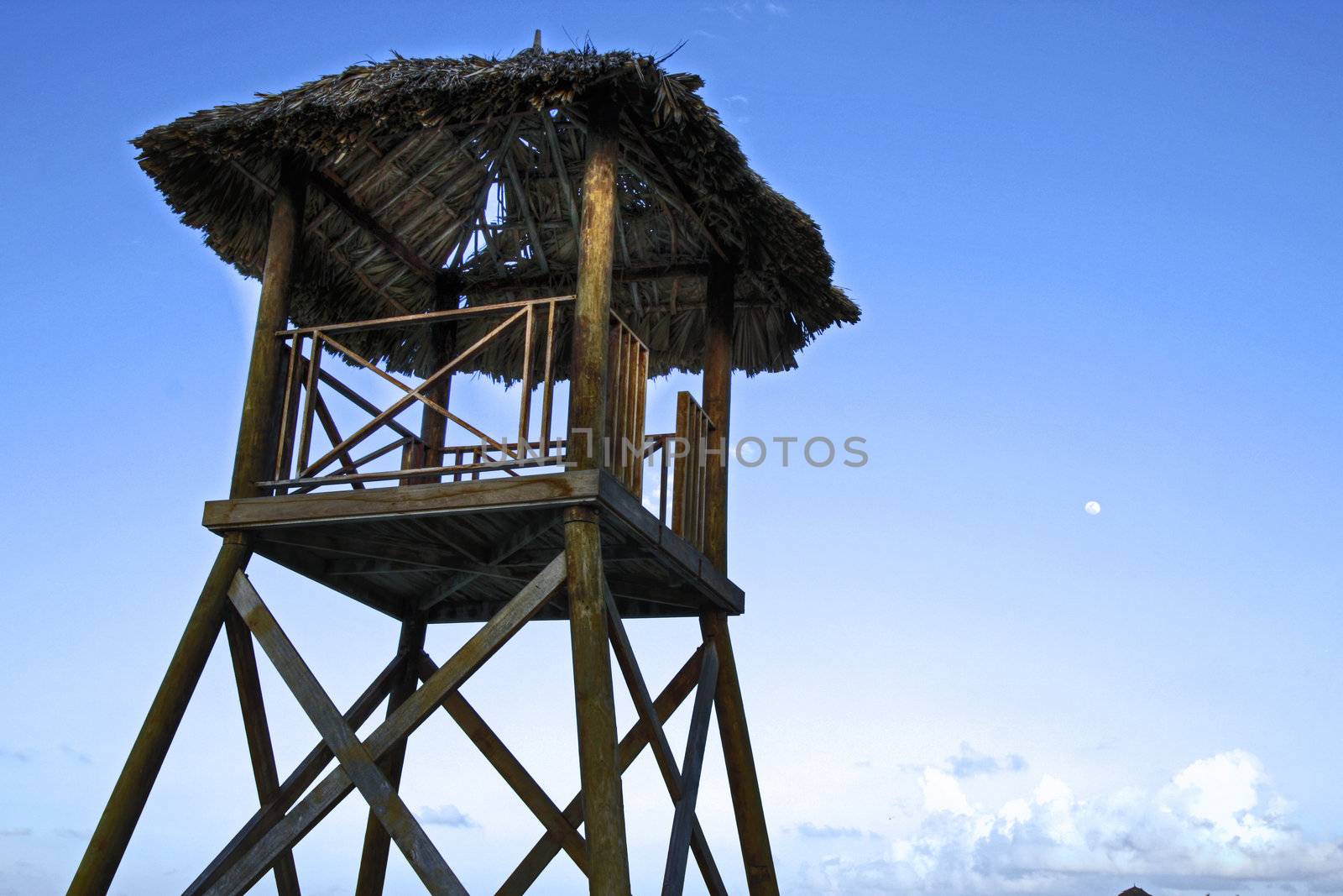 Tropical watchtower overlooking a beach in silhouette