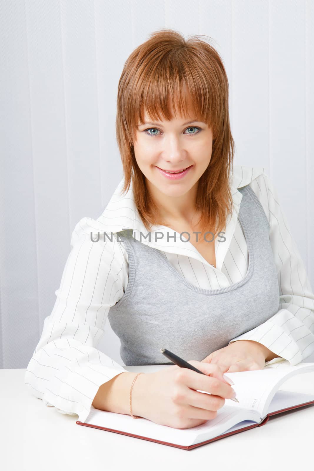 Attractive girl with a notepad and pen