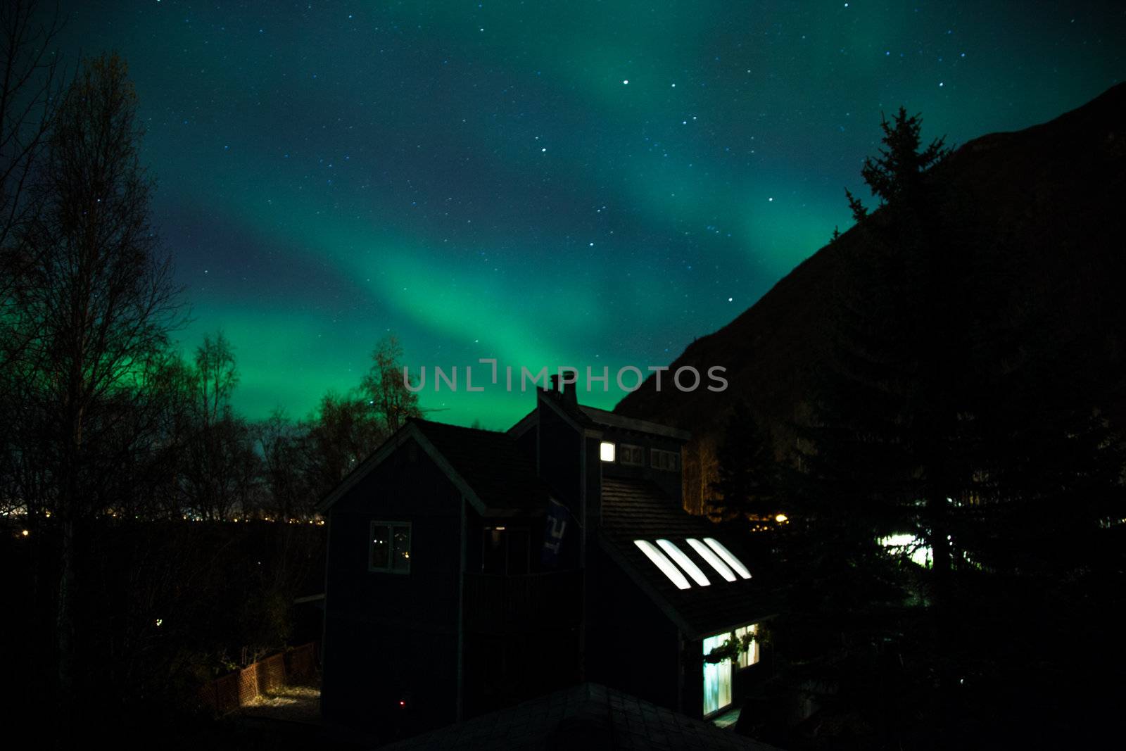 Northern lights shine brightly over a home