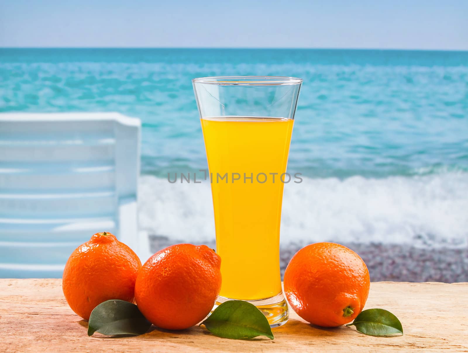 orange juice in a glass on a table with oranges