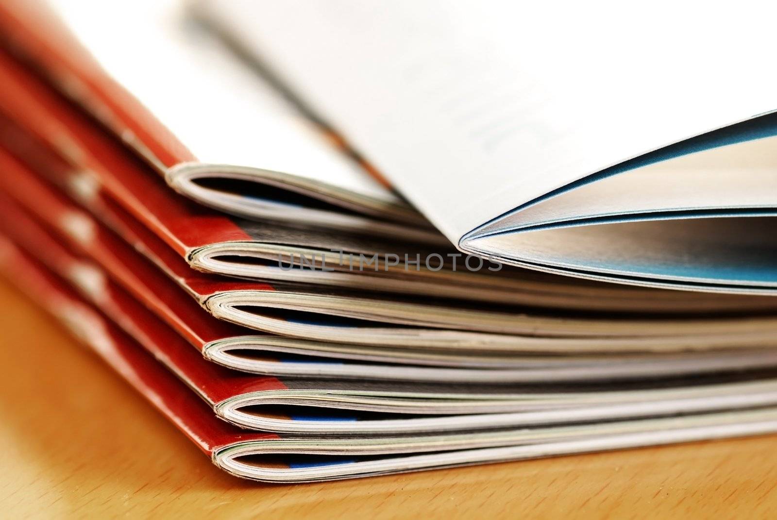 stack of same magazines with red covers closeup