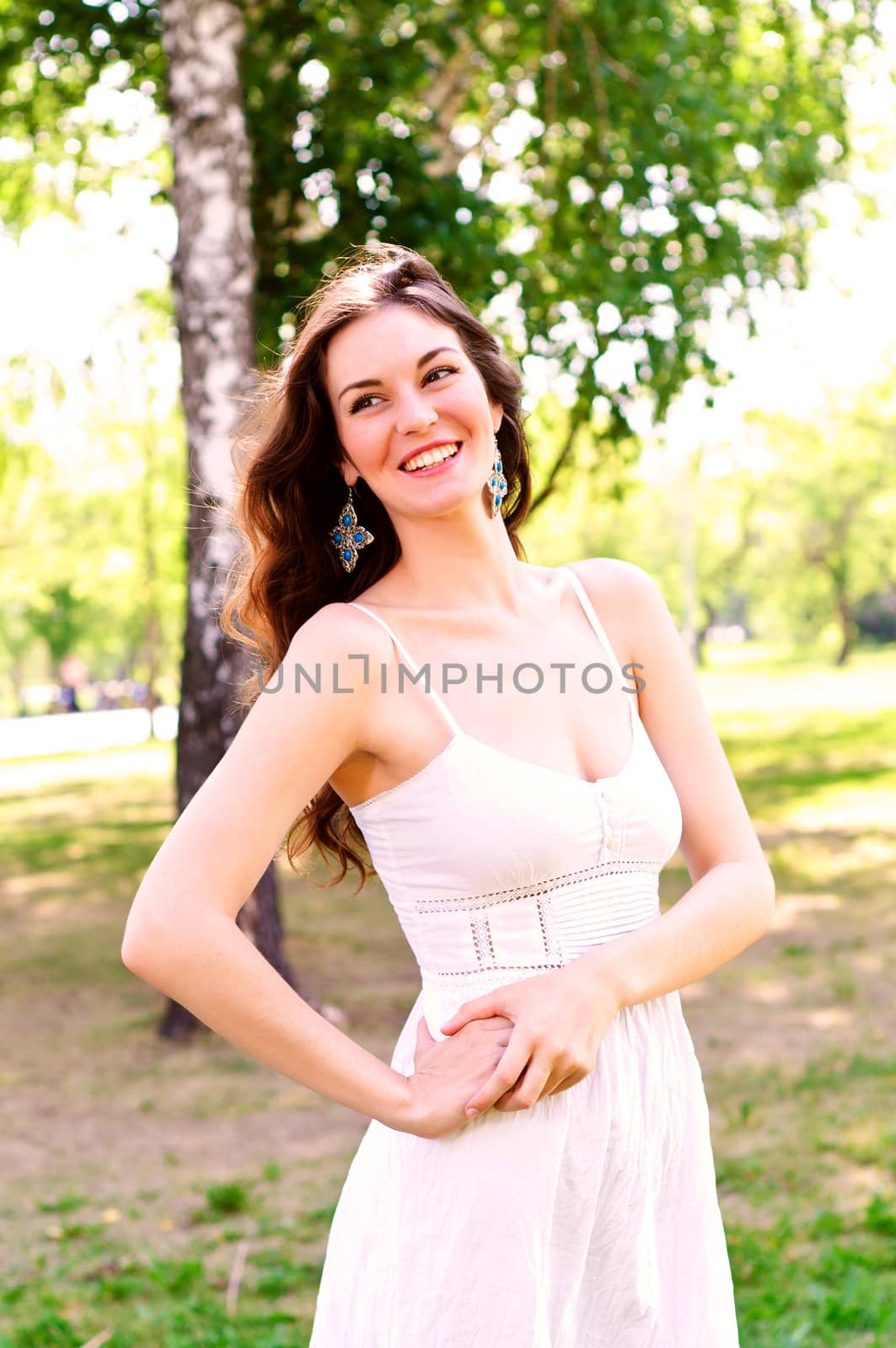 Portrait of an attractive woman in the park, smile and happy
