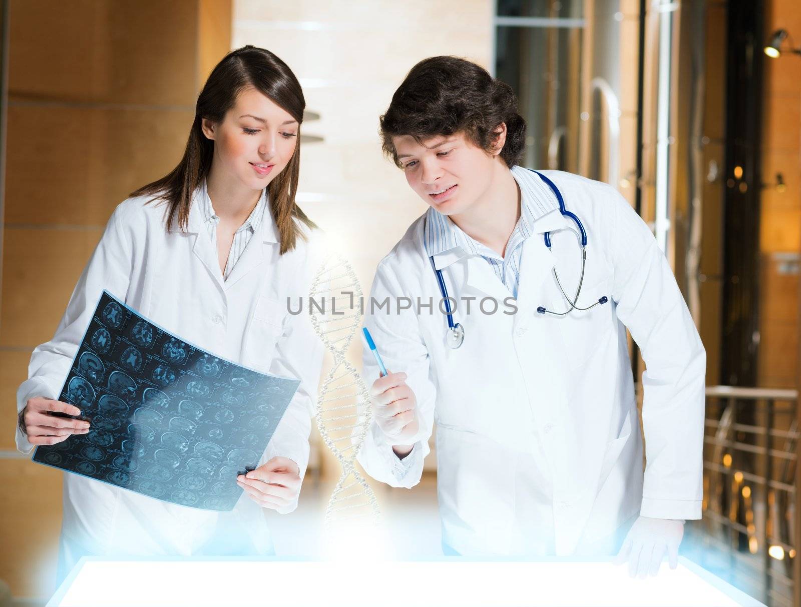 two doctors stand near glowing table discussing. projected objects on a desk