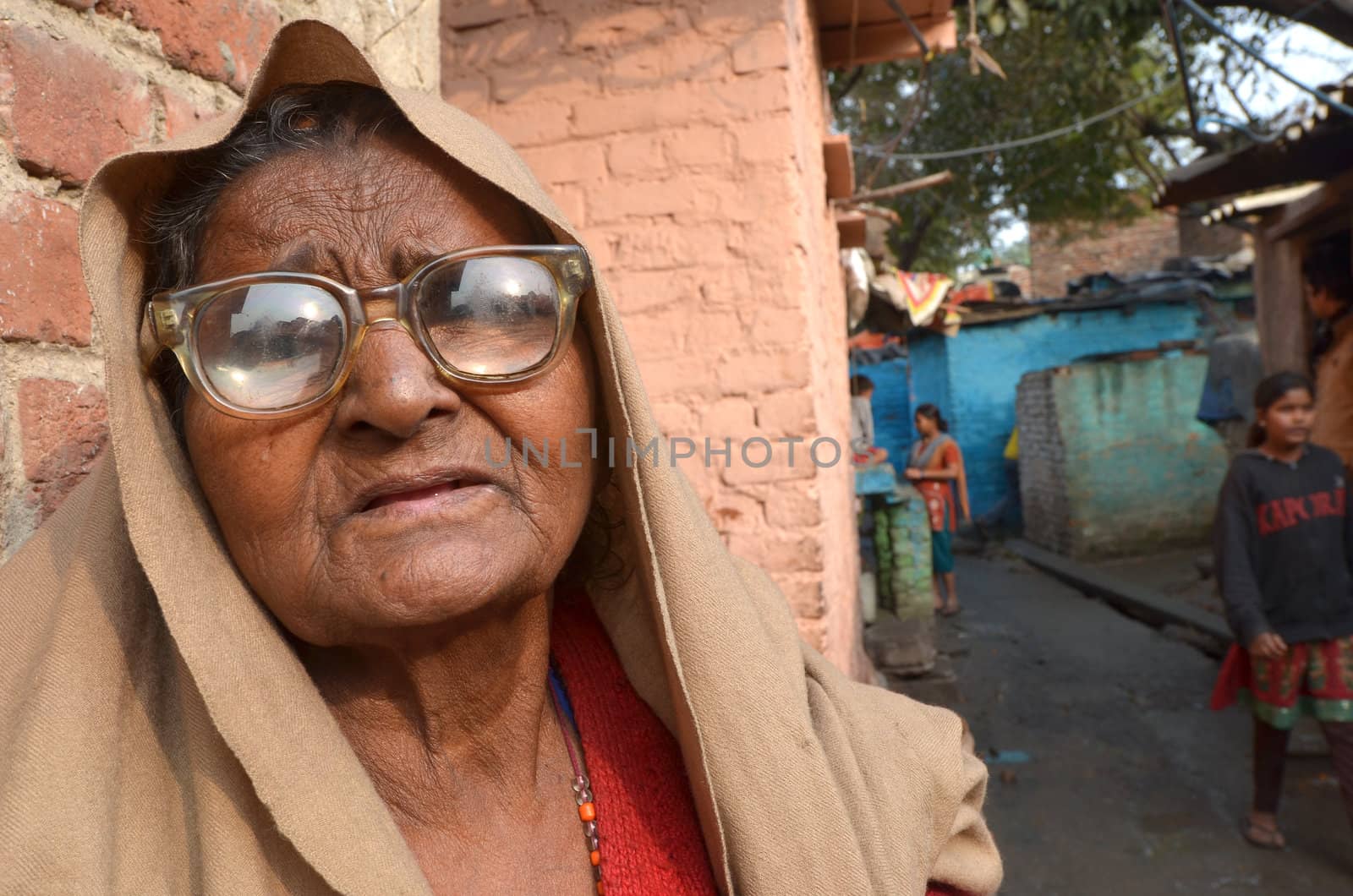 New Delhi,India-February 4, 2013:Portrait of a elderly woman near his home located in the poor neighborhood of New Delhi in February 4,2013.  In New Delhi dramatically increases the number of poor people living in slums