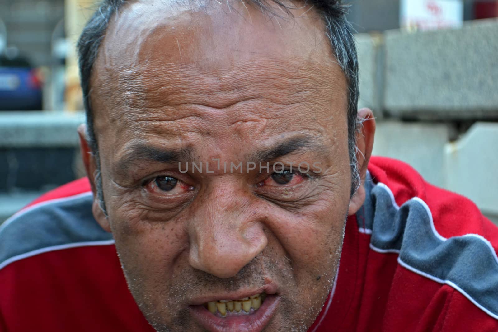 Homeless man speaking with a bitter expression on his face (Near Keleti Railway Station, Budapest, Hungary, June 18th 2011)