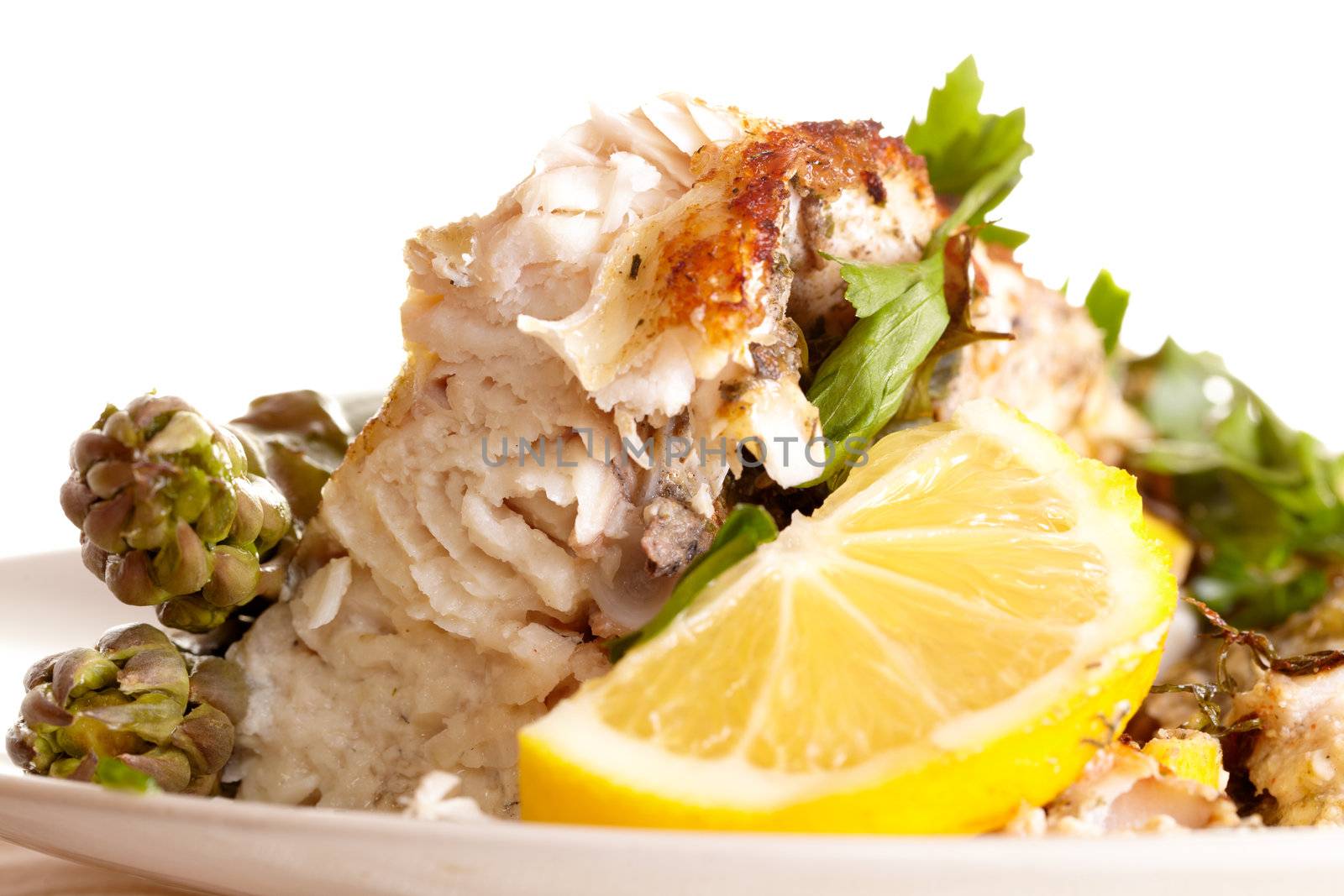 Fish dish with asparagus, greens and lemon.