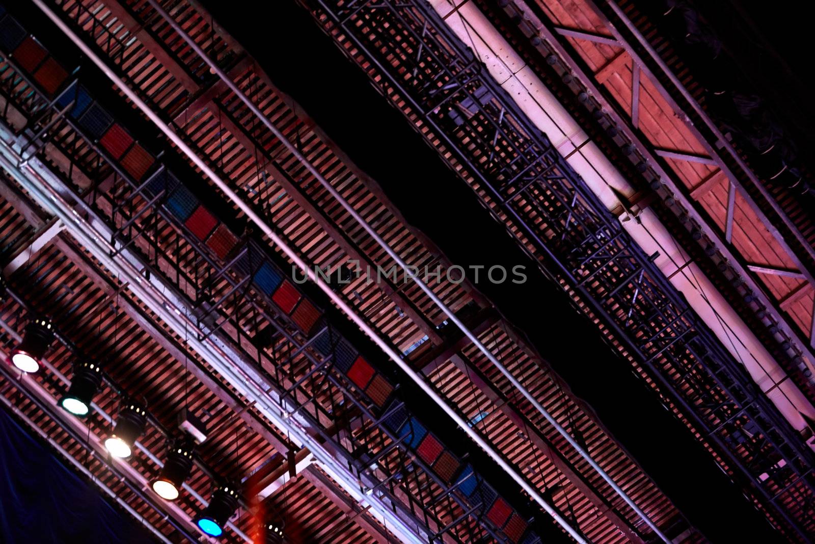 Dark theatre scaffold from low angle - construction background with spotlights.