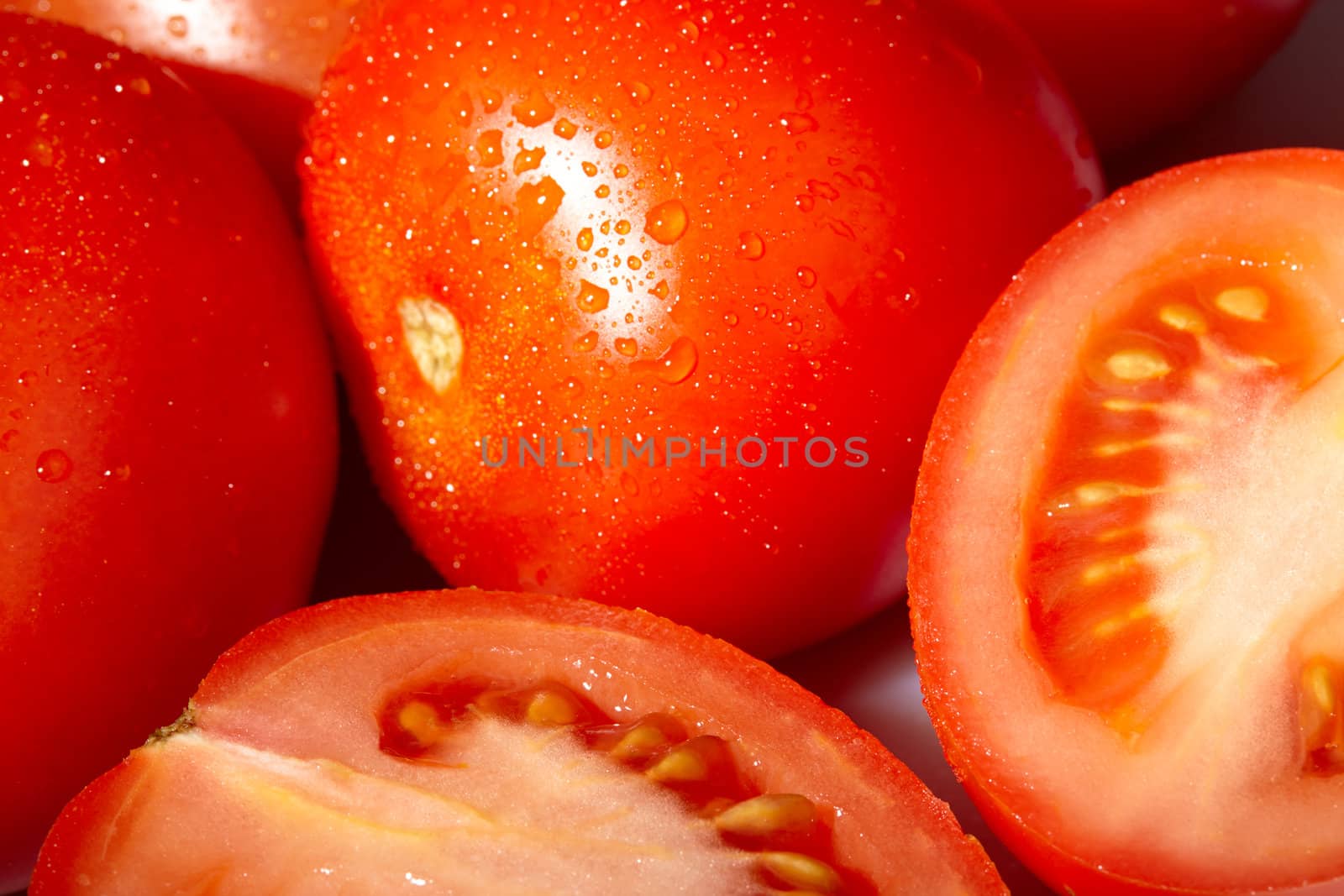 Fresh red tomatoes with water drops. Macro shot.