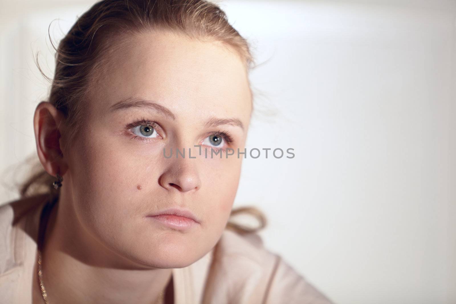Young woman is watching an interesting film on tv. Close up shot.