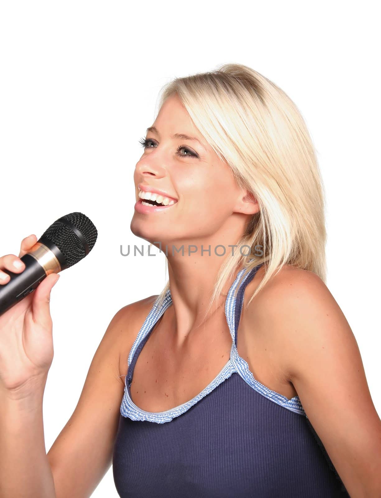 Beautiful young blonde lady singing into a microphone - isolated on white