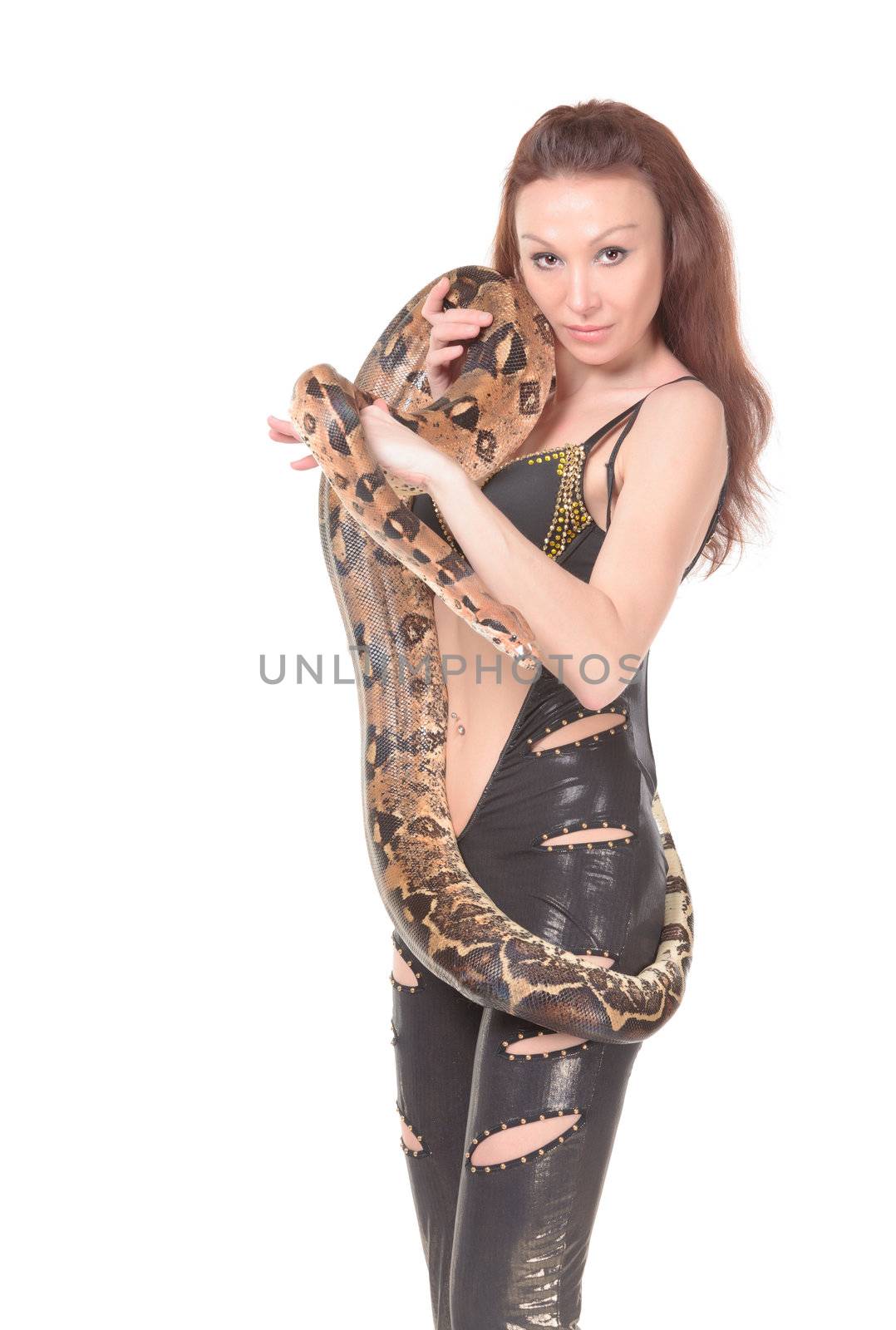 Sexy attractive young woman in leathers posing with her boa wound round her body
