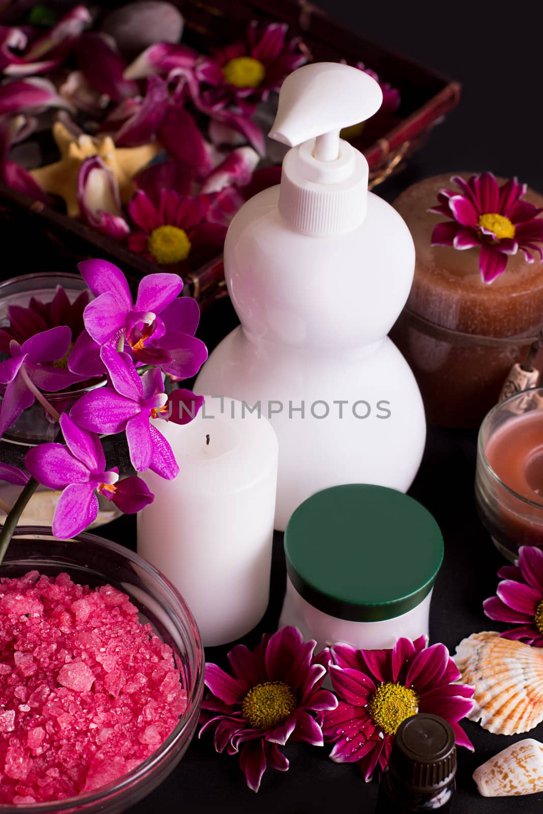Orchids, spa treatment products isolated on black