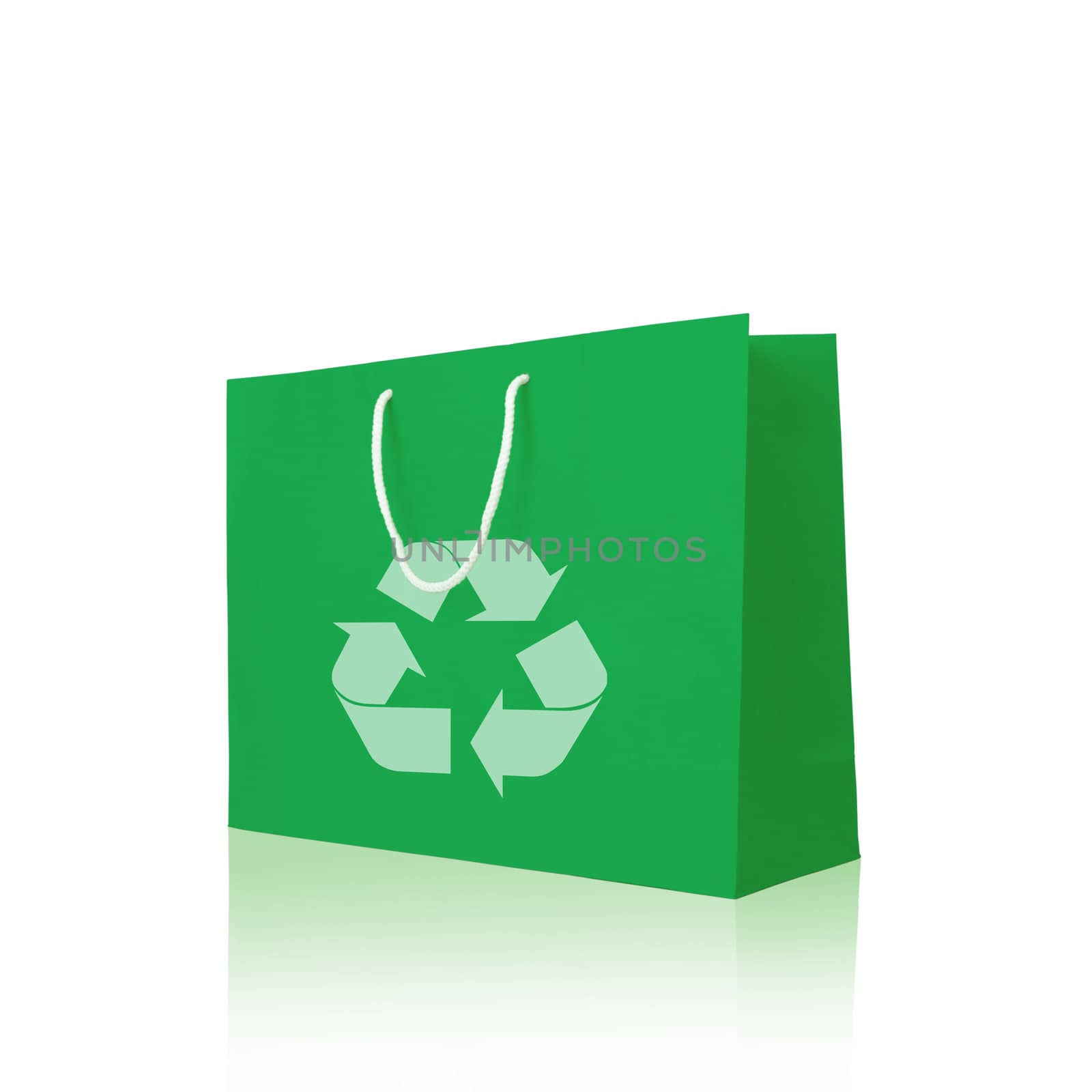 Green recycle paper shopping bag on reflect white floor 