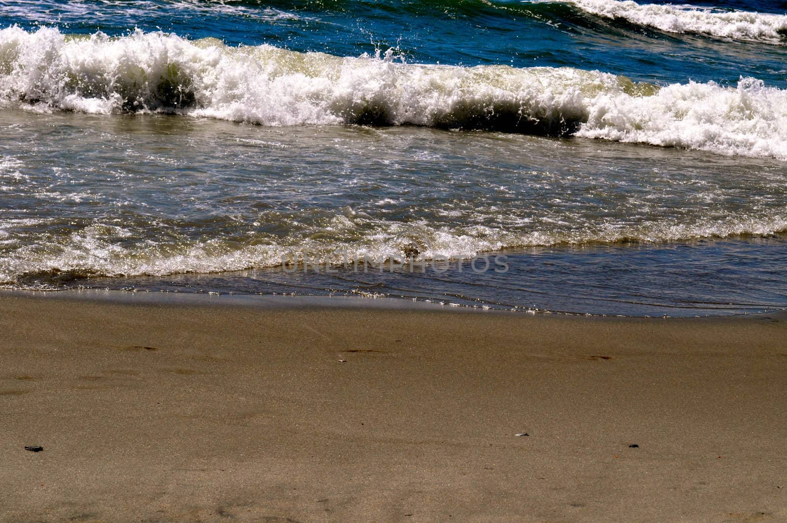 Sand and waves by RefocusPhoto