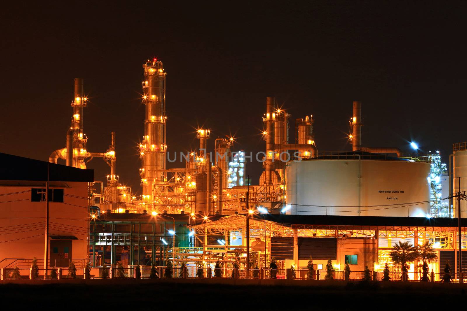 closeup of  petrochemical oil refinery plant and water storage tank