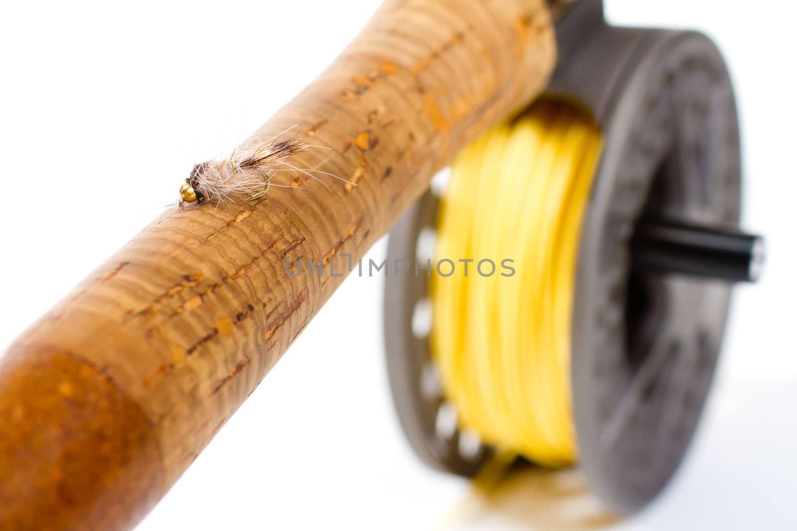 A hares ear bugger nymph is photographed in a lighting studio with a white background while rigged up and ready to fish on this fly rod and reel setup.