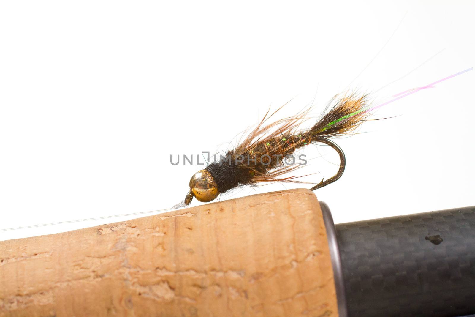 This big fly fishing fly is isolated on a cork handle in the studio for a detail fly fishing color image.