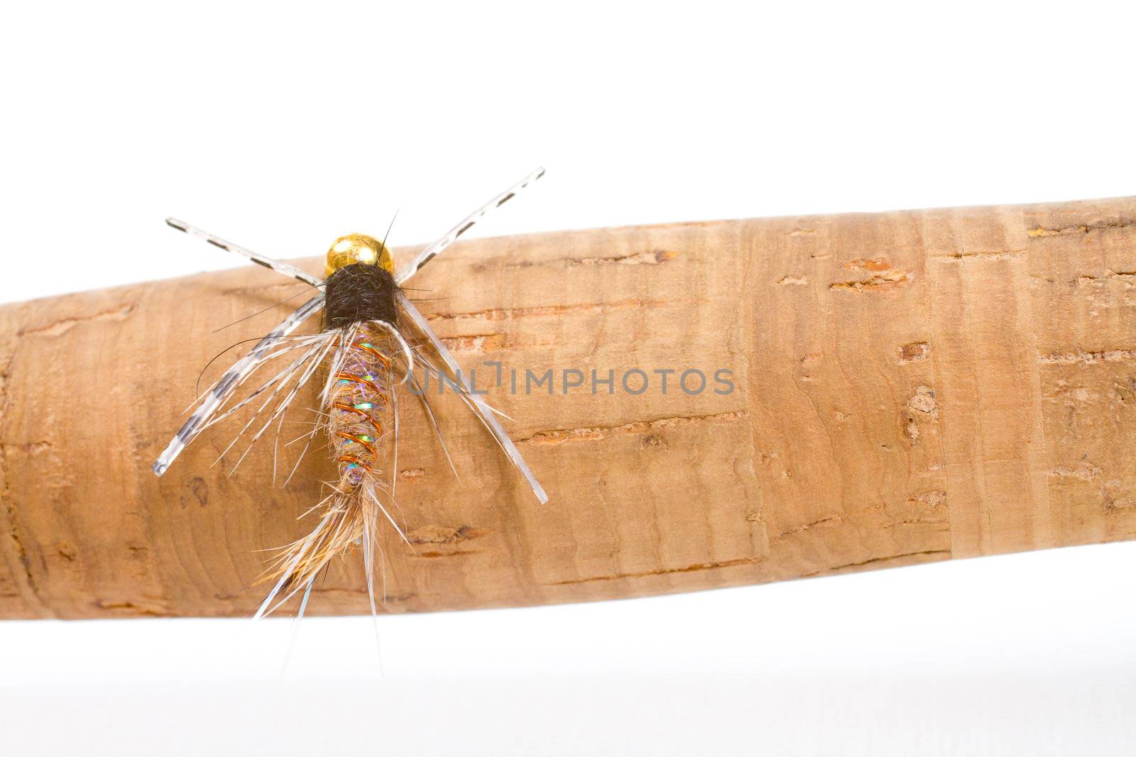 This big fly fishing fly is isolated on a cork handle in the studio for a detail fly fishing color image.