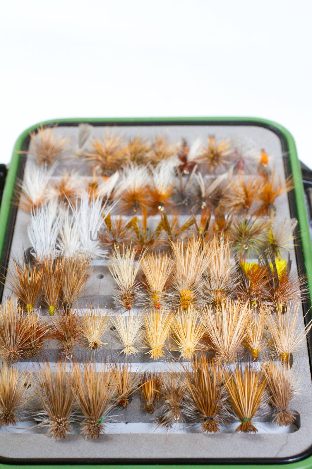 A fly fishing box of flies contains dry flies including caddis, bwo, adams, stone, and more in this abstract color image detail for the recreational pursuit.