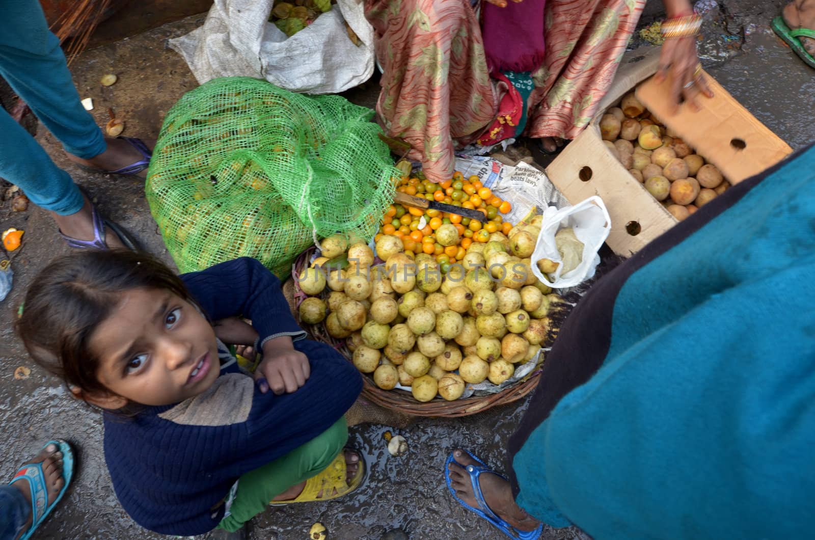 New Delhi,India-February 4, 2013:An unidentified child sell fruit in a  market in New Delhi in February 4,2013 the food market in New Delhi is the largest one in India.