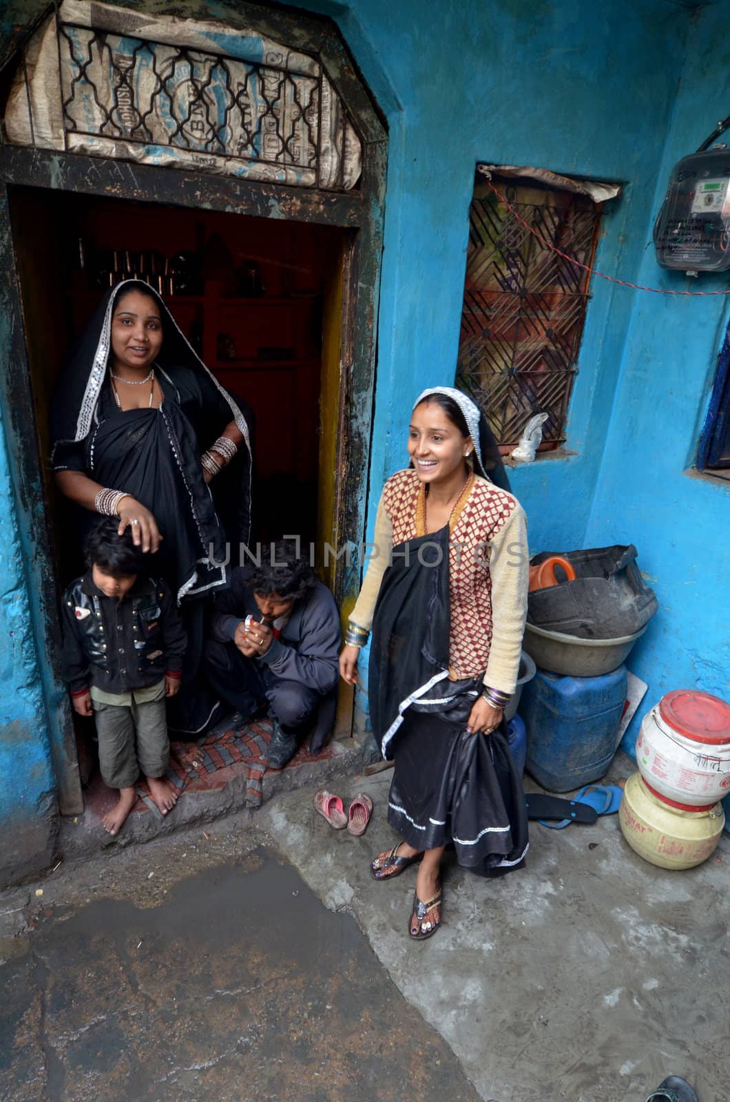 New Delhi,India-February 4, 2013:
two  women speak in the courtyard of his house in the slum in New Delhi in February 4,2013 . In India dramatically increases the number of poor people living in slums